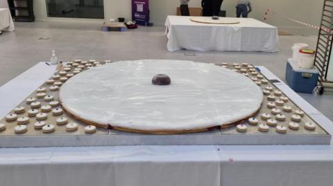 a giant empire biscuit, surrounded by smaller ones