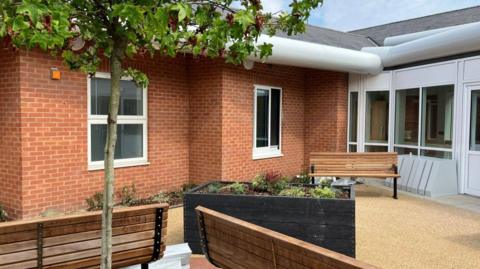 Garden space at Bluebell ward, including benches and raised planters