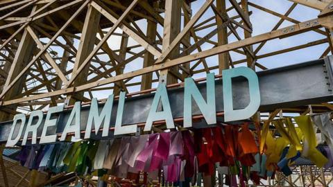 The Dreamland sign below a wooden rollercoaster
