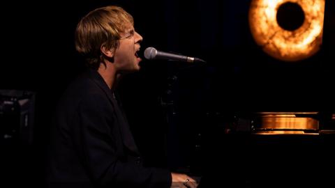 Tom Odell performing on piano