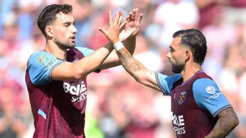 Konstantinos Mavropanos high-fives Taty Castellanos after West Ham's equaliser