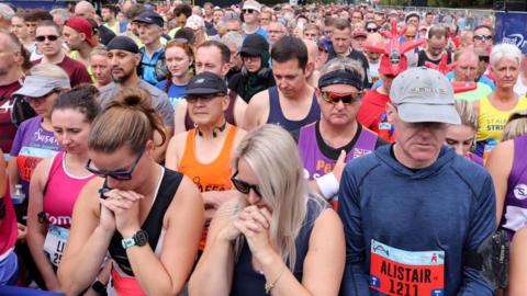 Runners bow head in minute's silence