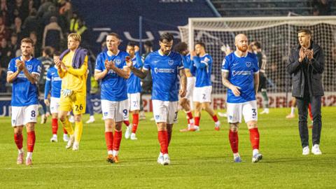 John Mousinho and Pompey players applaud the fans after the draw with Watford