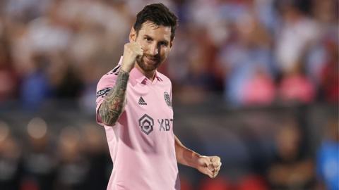 Lionel Messi holds up his fist as he celebrates