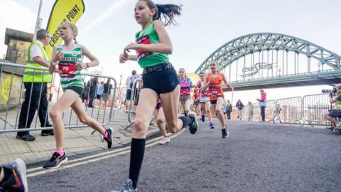 Young runners cross the Swing Bridge as part of the Mini and Junior Great North Runs in 2021
