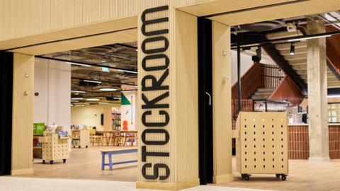 Stockroom has a wooden entrance with Stockroom written in black letters