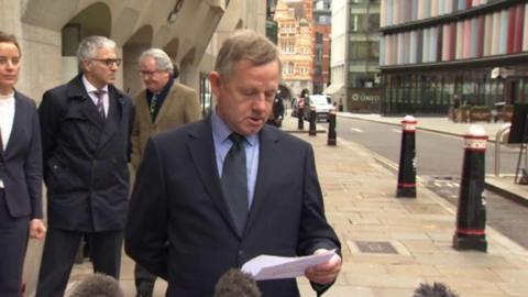 Andy Hill reads a statement outside court