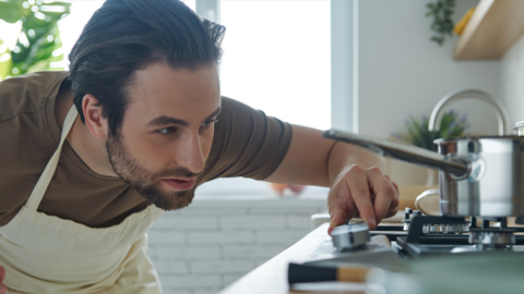 Man turns down gas cooker