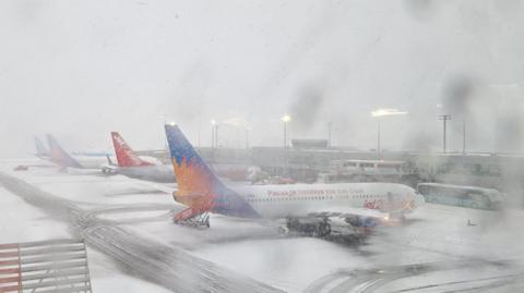 Heavy snow falls on Newcastle Airport as several planes sit on the Tarmac. 