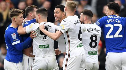 Cardiff and Swansea players in a melee