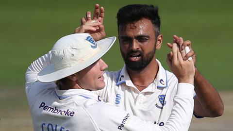 Jaydev Unadkat of Sussex celebrates with his team-mates after taking a wicket