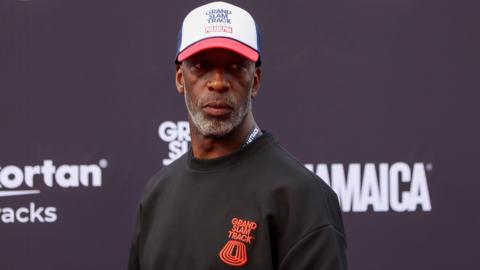 Former athlete Michael Johnson wearing a Grand Slam Track jumper and cap at the league's event in Philadelphia in 2025