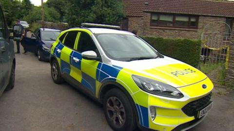 A police car outside a house