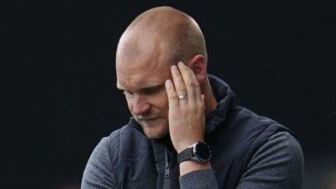 Liam Manning looking dejected