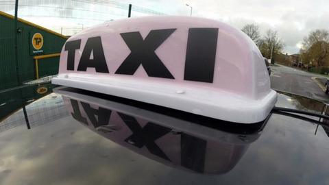 Taxi sign on car