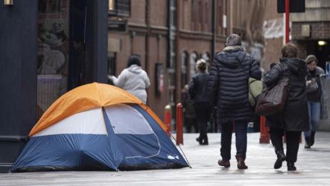 File image showing a blue, white and orange tent erected on a street in central London