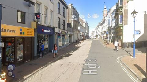 High Street, Ilfracombe - a two-lane town centre road with shops either side