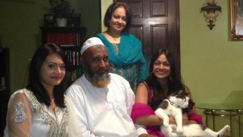 Mr Monir with his two daughters, wife and cat in family photograph