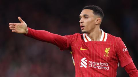 Trent Alexander-Arnold points to a team-mate while playing for Liverpool