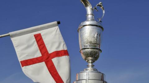 The Claret Jug trophy and the England flag