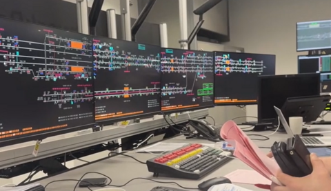 A series of computer monitors with white lines against a black background.