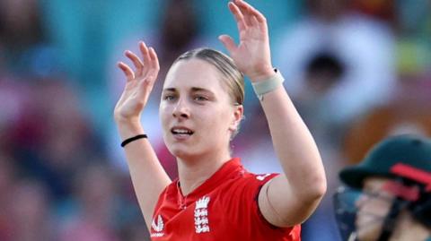 Freya Kemp holds her arms aloft