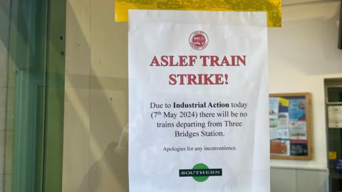 A sign at Three Bridges station warning of strike action