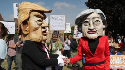 Demonstrators wearing Donald Trump and Theresa May paper mache heads join the protest in Butler's Cross, close to Chequers