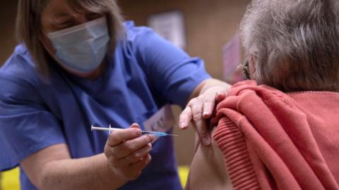 Picture of elderly woman being vaccinated