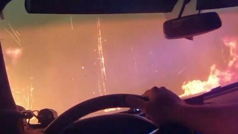 Inside of a car as it drives through fire