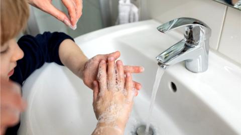 child washing hands