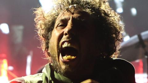 Zack de la Rocha performing seated at Madison Square Garden in New York on 8 August