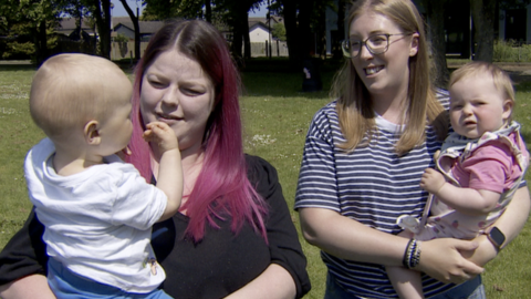 Laura Magee and Rachel Smyth hold their babies in a park