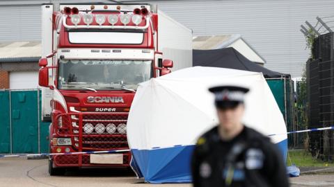 Police officer and forensic tent near lorrt