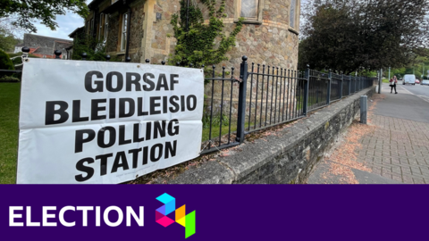 Polling station sign with BBC election branding at the bottom of the image
