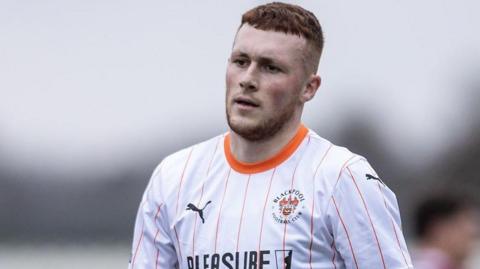 Sonny Carey wearing Blackpool's white-shirt away kit against Northampton Town