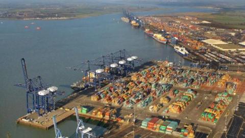 Felixstowe port from the air, cranes and containers are visible as is the sea.