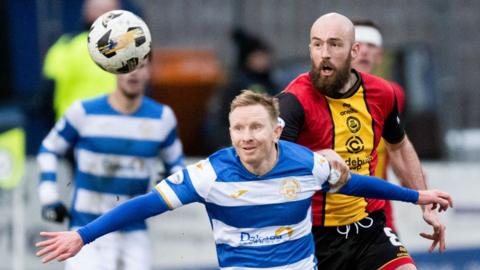 Greenock Morton's Ali Crawford holds off Partick Thistle's Stuart Bannigan