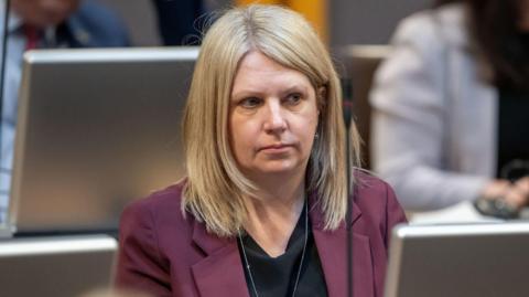 Hannah Blythyn sitting in the Senedd chamber