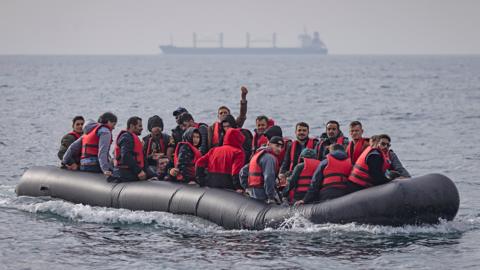 An inflatable craft carrying migrants across the Channel in August