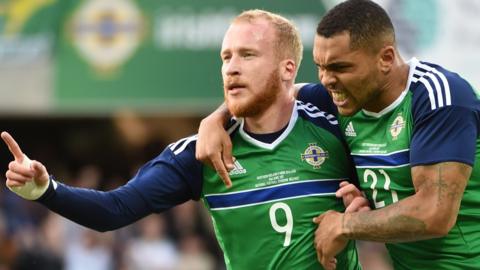 Liam Boyce celebrates his first international goal with strike partner Josh Magennis