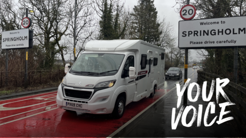 White campervan driving past Springholm 20mph sign