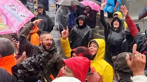 Protestors dance and sing to music being blasted by the government to disperse them as they rally against coronavirus disease vaccination mandates near the Parliament building in Wellington, New Zealand on 13 February 2022