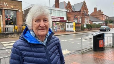 Resident of Radcliffe-on-Trent, Jerry Siverns, stood on the main road with the InPost lockers in the background.