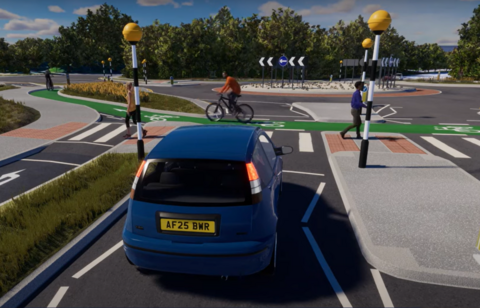 A blue car waiting at a zebra crossing as both pedestrians and a cyclist cross. There is a roundabout in the background.