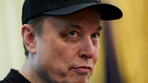 Close-up of Elon Musk's face with a black eye.