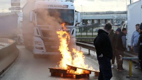 French fishermen block trucks at the Eurotunnel Freight Terminal