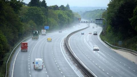 An aerial view of a motorway in wet conditions. 