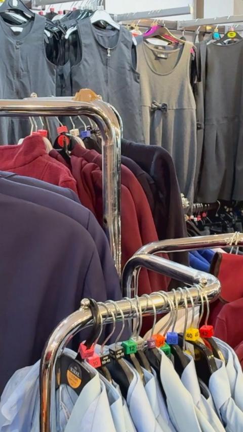 School uniforms hanging on clothes rail