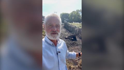 man standing at wildfire